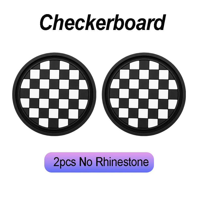 A pair of black and white checkered coasters for car cup holders.