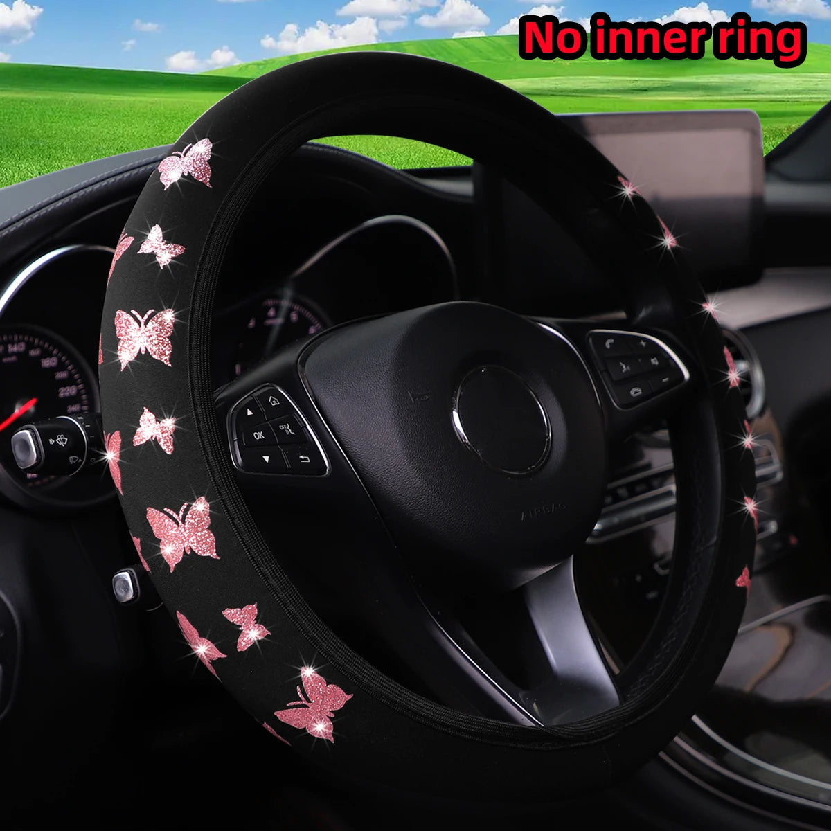Black steering wheel cover with a glitter pink butterfly pattern installed in a car interior.