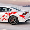 A white sports car features red wolf decals on the rear fender and side panel in a bright outdoor setting.