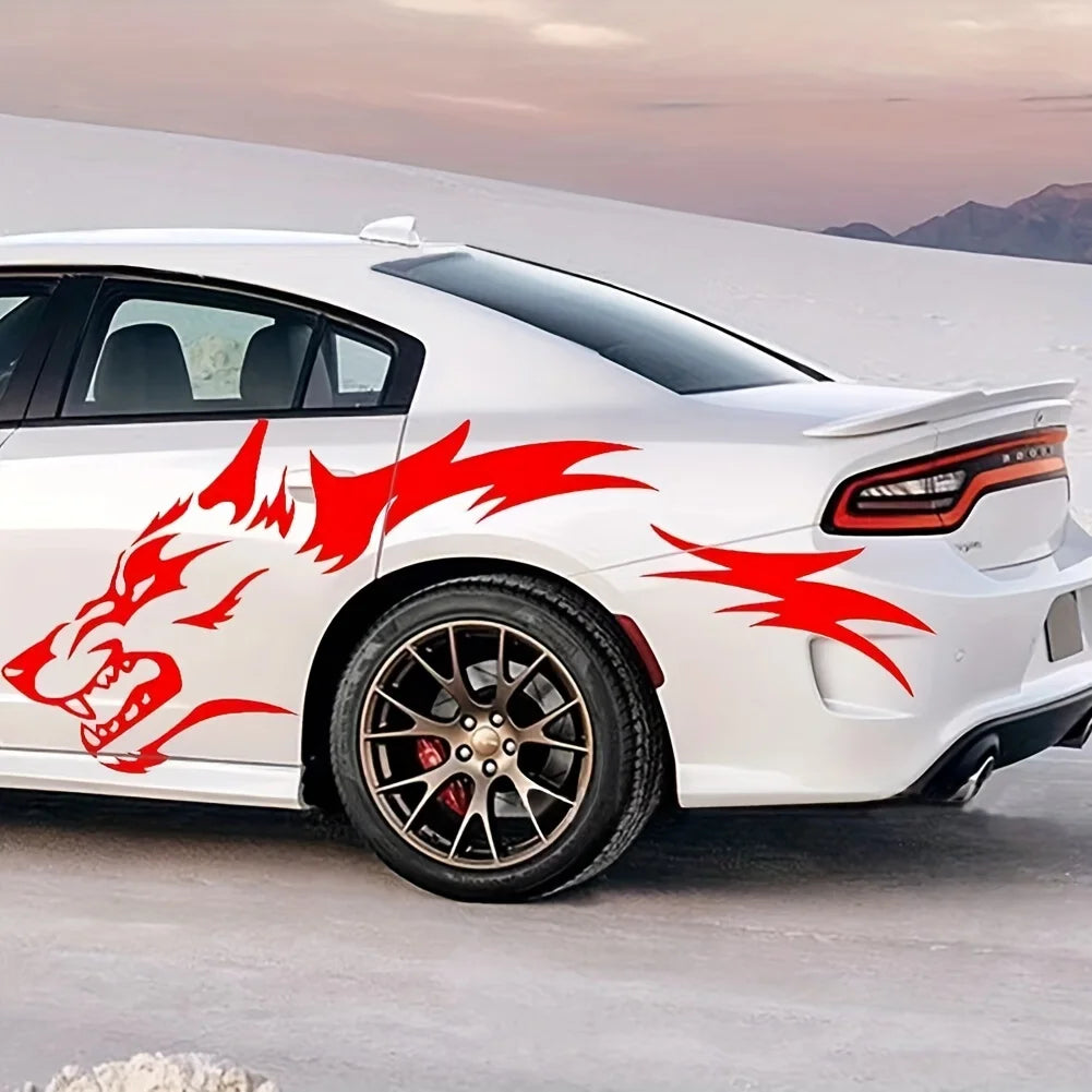 A white sports car features red wolf decals on the rear fender and side panel in a bright outdoor setting.