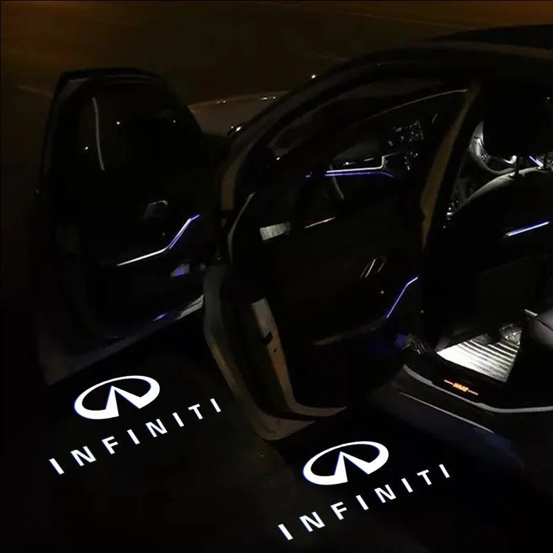 Interior view of a car door with illuminated light lines, showcasing the Infiniti brand logo on the floor.