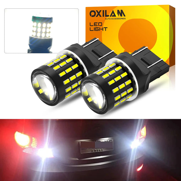 A pair of aftermarket LED car light bulbs with yellow accents shown next to their packaging box.