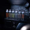 A row of small glass tubes containing LEDs is displayed on a dark electronic device with a dial and an off switch.