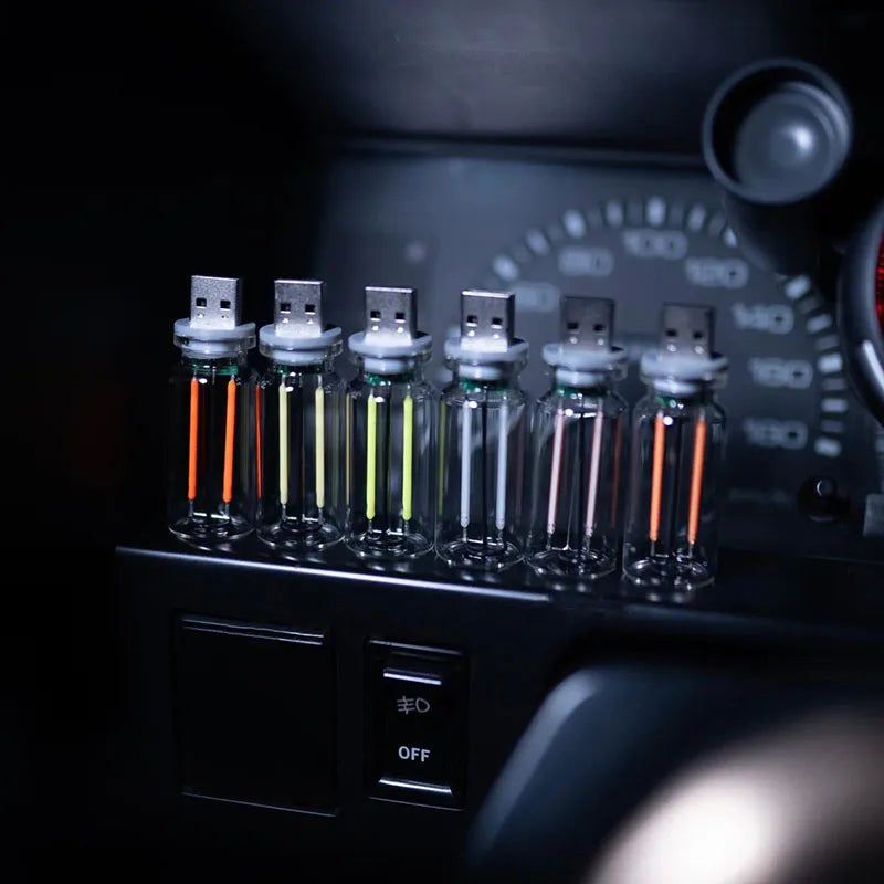 A row of small glass tubes containing LEDs is displayed on a dark electronic device with a dial and an off switch.