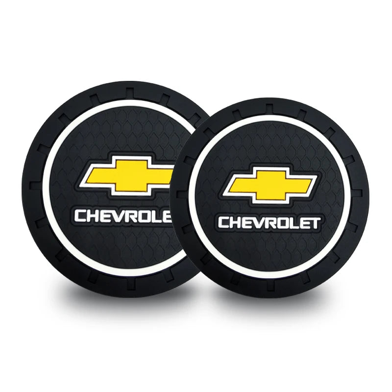 A set of two black and yellow Chevrolet emblem anti-slip coasters.