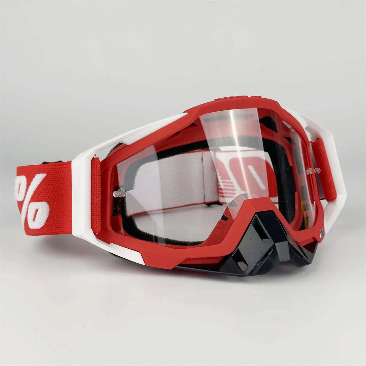 Red and white off-road motorcycle riding goggles with clear lenses and black frame