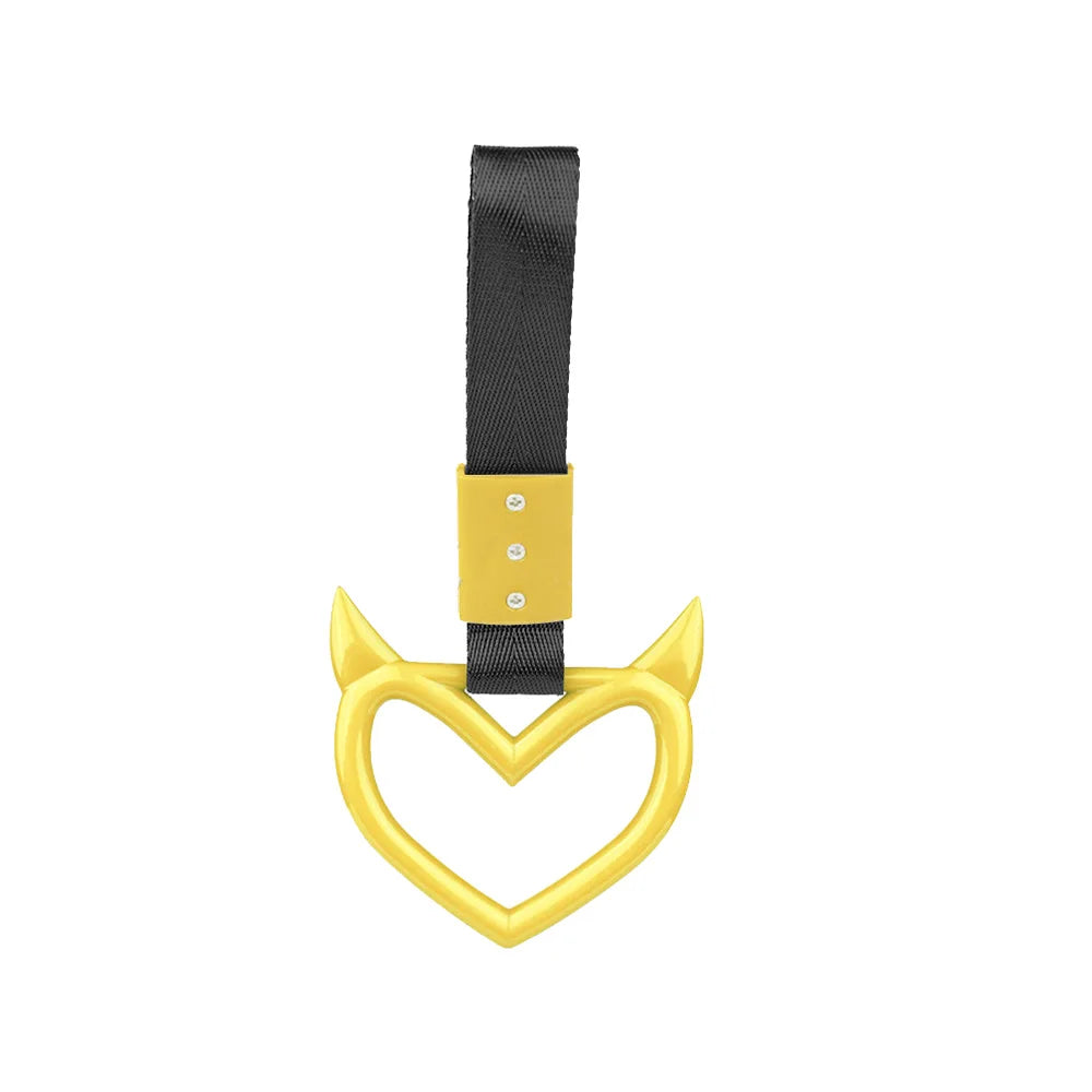 A yellow heart-shaped handle accessory with a black strap and gold accents for automotive use.
