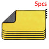 A set of five yellow microfiber car cleaning towels stacked together.