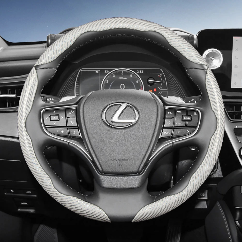 Interior view of a Lexus steering wheel with carbon fiber patterned covers and controls.
