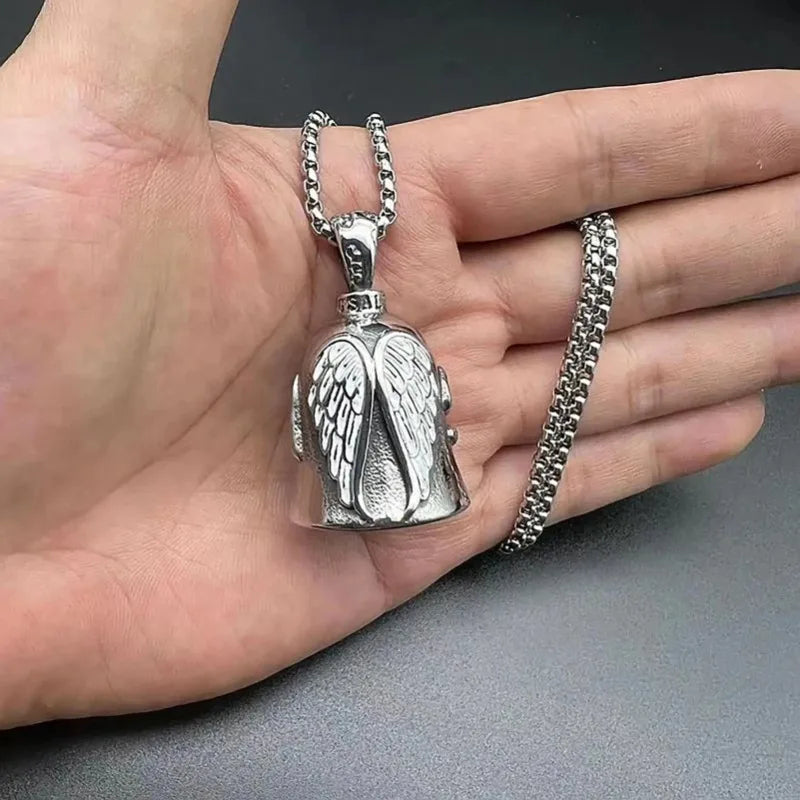 Silver angel guardian riding bell for motorcycle or bicycle shown on a hand.