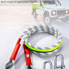 A coiled nylon towing rope with a U-shaped hook and metal shackles is displayed next to a pickup truck.