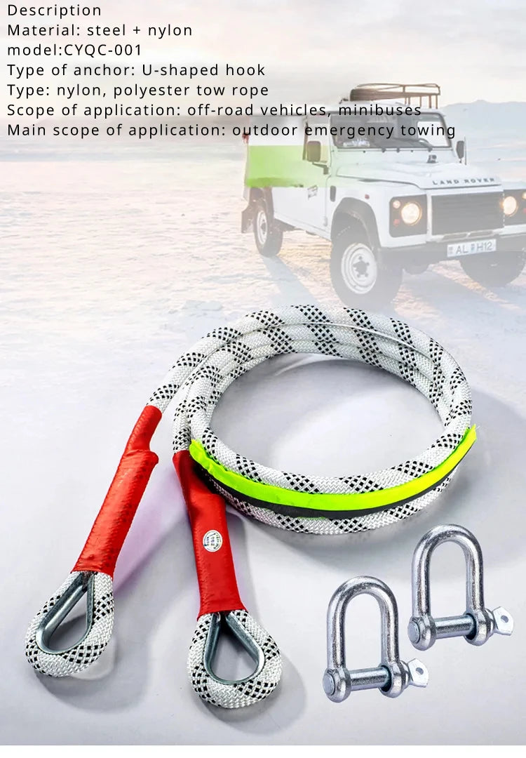 A coiled nylon towing rope with a U-shaped hook and metal shackles is displayed next to a pickup truck.