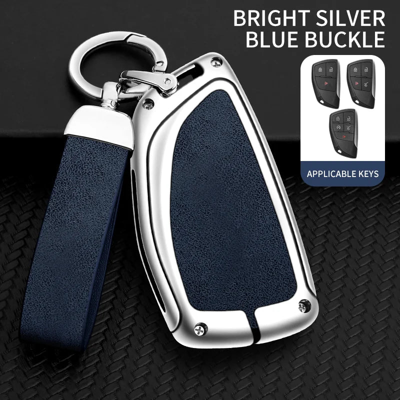 A bright silver blue buckle car key case with a dark blue strap and multiple keys displayed on a black textured surface.