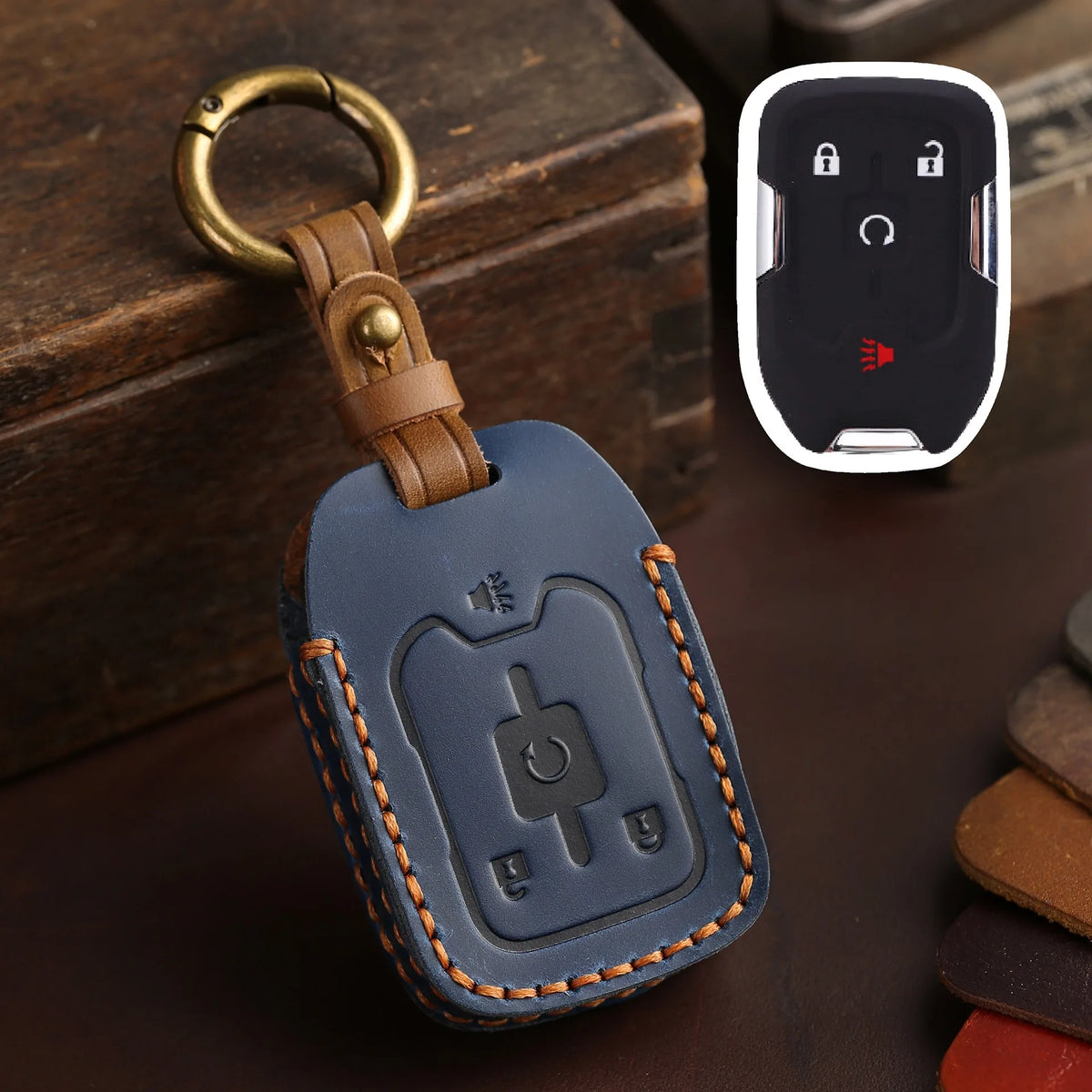 A dark blue leather key cover with a brass keyring is shown next to a white electronic fob.