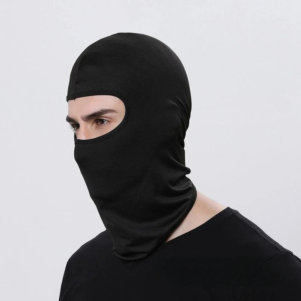 A person wearing a black all-weather windproof balaclava face mask.