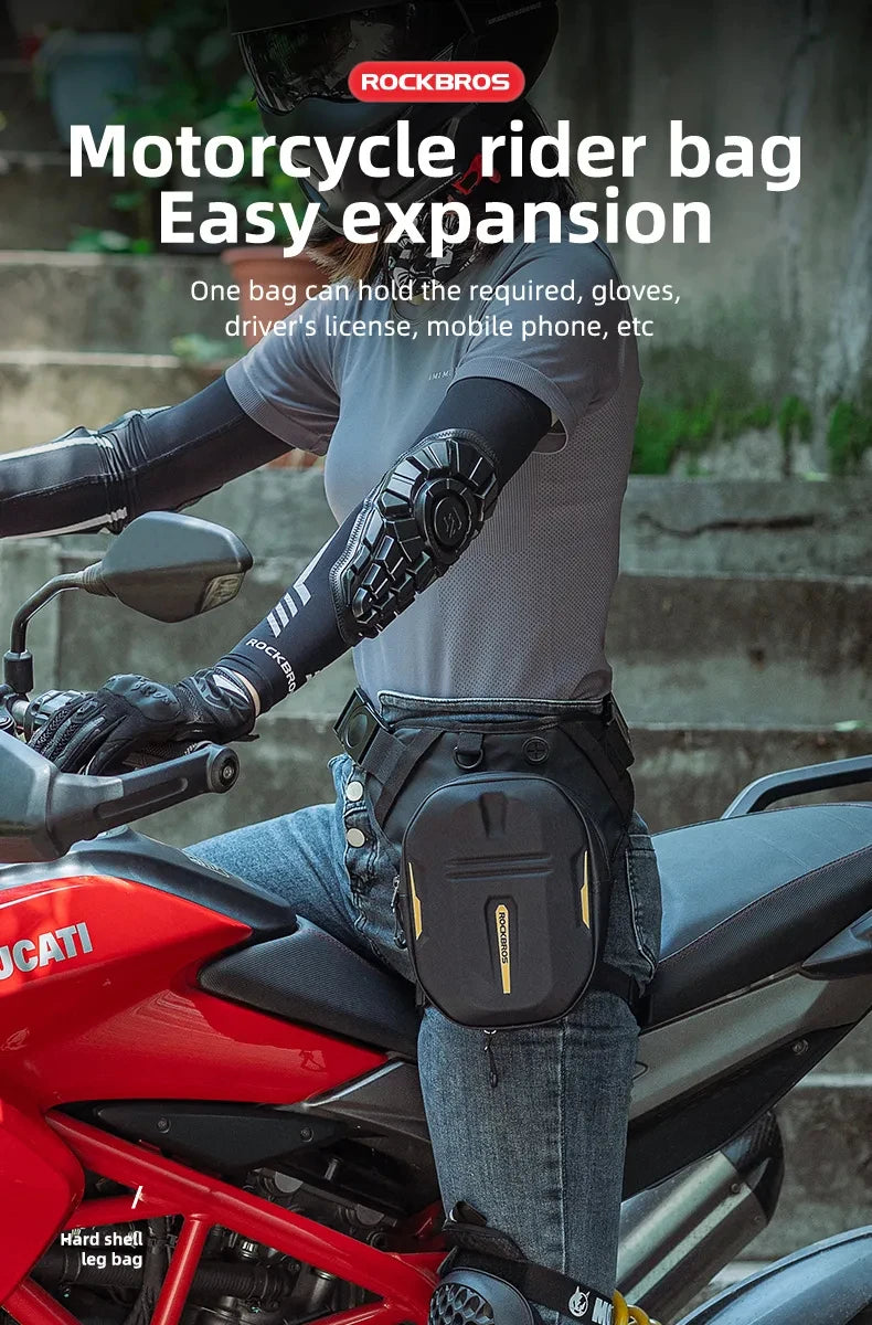 A person wearing a grey shirt and black gloves is mounting a red motorcycle with a black rider bag attached.