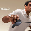 A man is demonstrating a retractable car charger, showing its length and functionality.