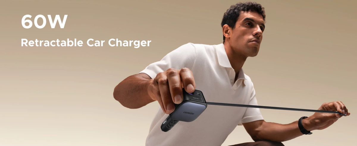 A man is demonstrating a retractable car charger, showing its length and functionality.
