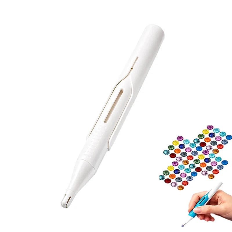 A white precision diamond painting bead dispenser pen is shown next to a hand holding a blue pen.
