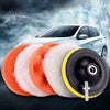A professional car polishing pad kit showing orange and white foam pads next to a black and yellow polishing disc.