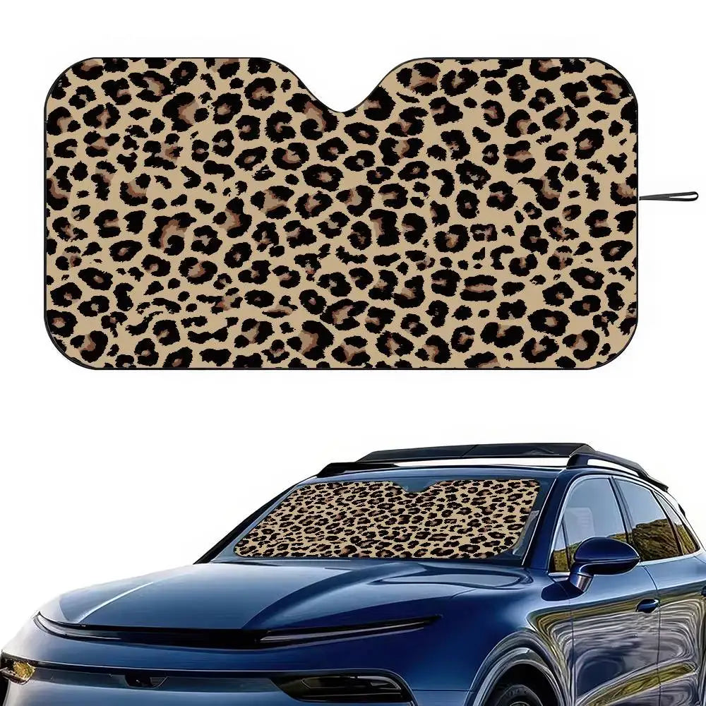 Leopard print car sunshade placed on the windshield of a blue car.