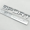 Silver metal badge spelling out SPORT LUXURY for a car decal.