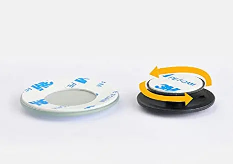 A white circular rearview mirror with an orange ring and a black base, shown next to its packaging.