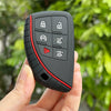 A hand holds a black universal key fob cover with multiple buttons for Chevy and GMC trucks.
