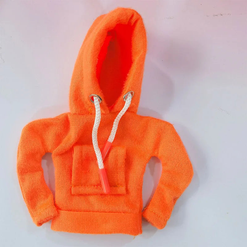 An orange hoodie with a hood and drawstring is displayed against a white background.