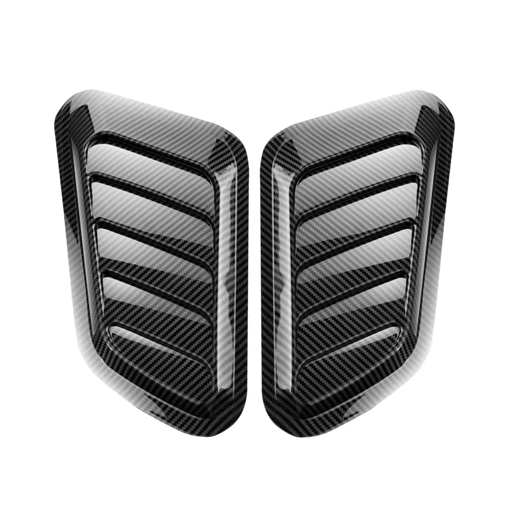 A pair of black decorative air intake vents for a car hood.