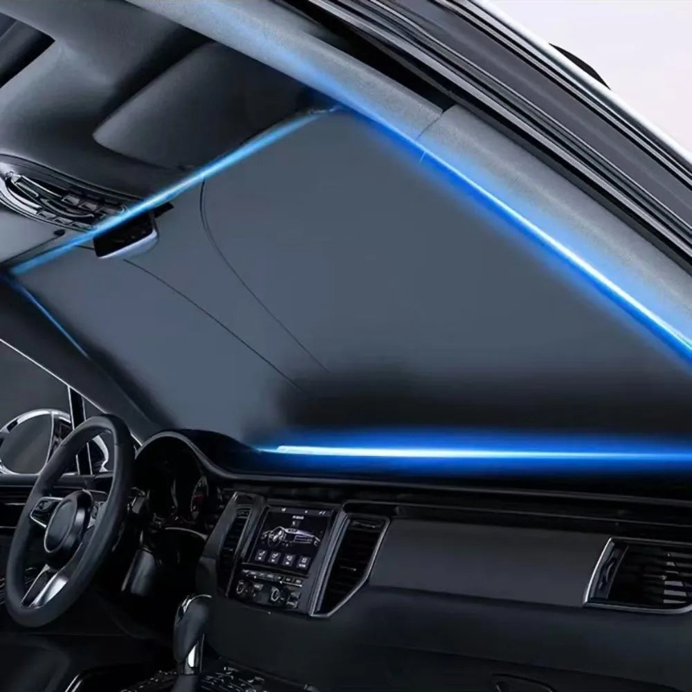 Interior view of a car showing a blue light strip on the windshield and dashboard.