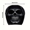 A black portrait print featuring a detailed skull design on a car headrest cover.