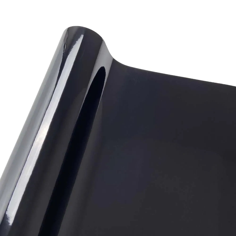 Close-up view of a glossy black vinyl car wrap film surface.