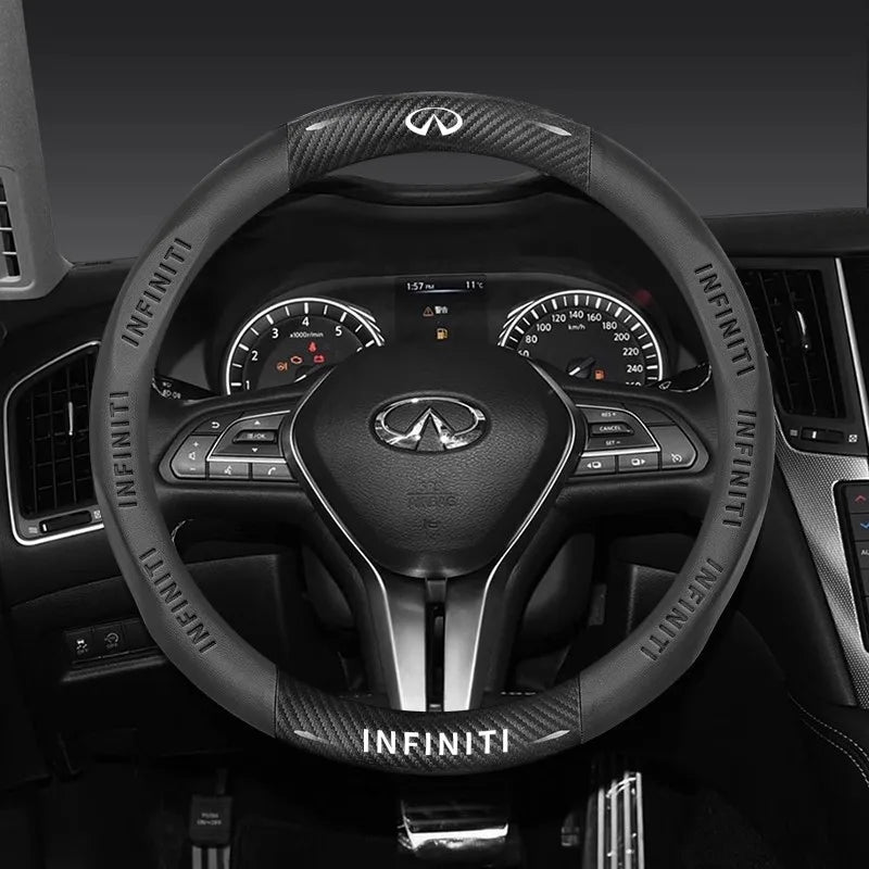 Black leather steering wheel with Infiniti logo and carbon fiber accents.