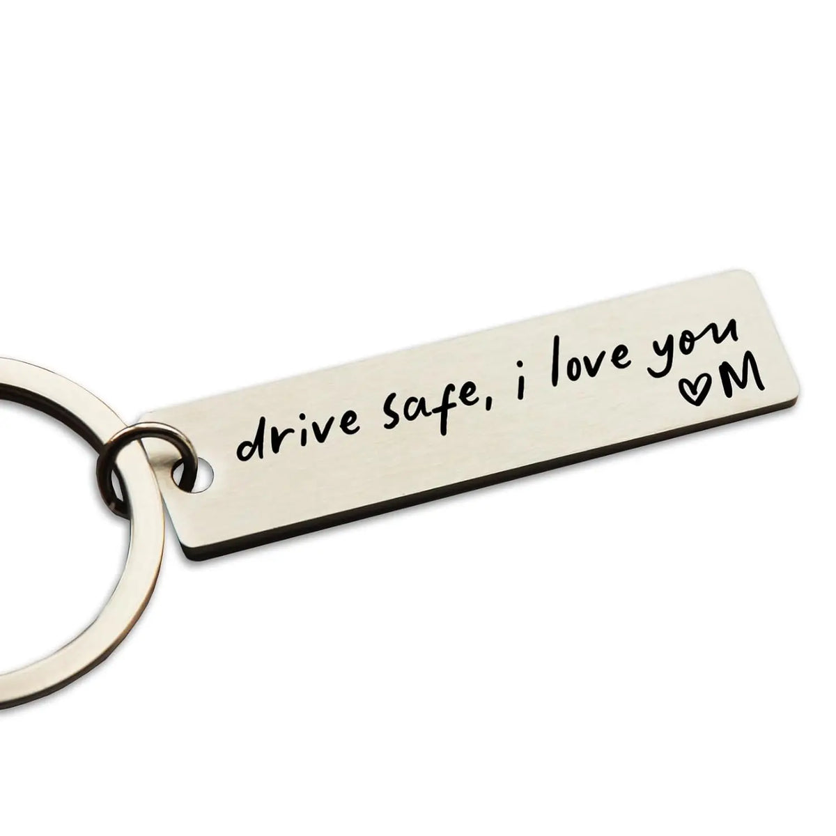 A stainless steel keychain tag engraved with the message drive safe i love you and a heart M