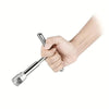 A hand is holding a metal car dent puller tool, demonstrating its use.