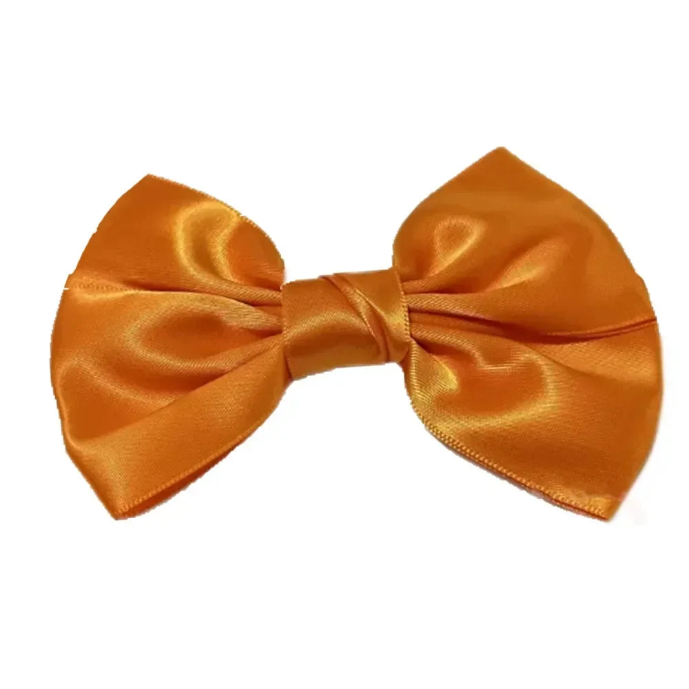 A handmade silk hair bow in a vibrant orange-gold color.
