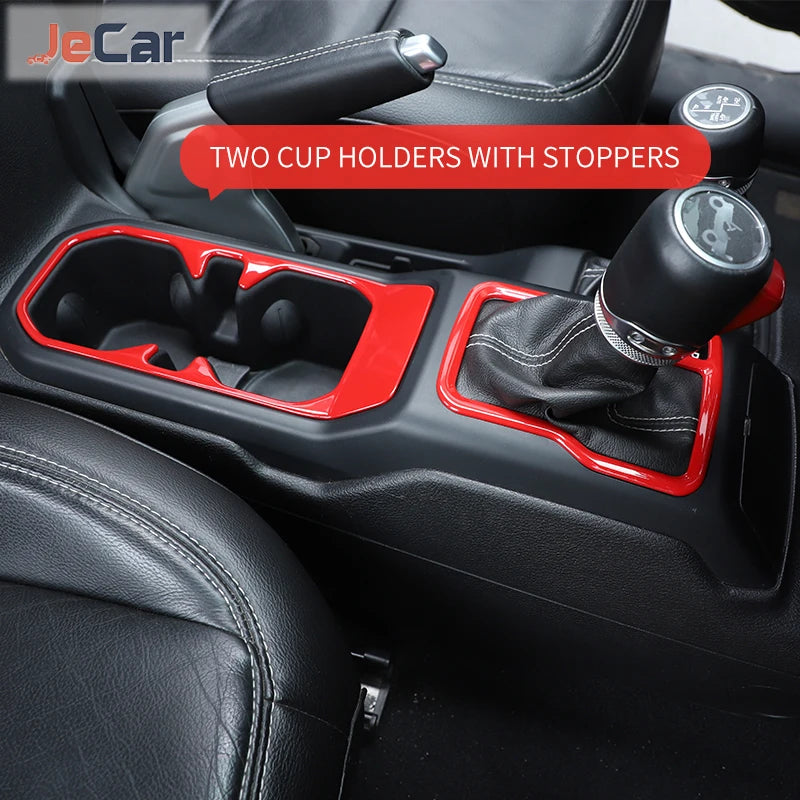 Red cup holders with stoppers installed in a black car gear shift panel trim.
