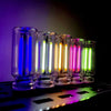 A row of USB touch dimmable LED night lights glowing in various colors on a dark surface.