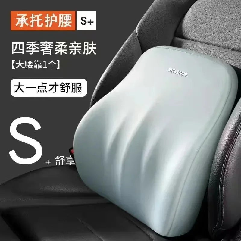 A light blue ergonomic car headrest cushion with supportive contours is shown in a dark car seat interior.