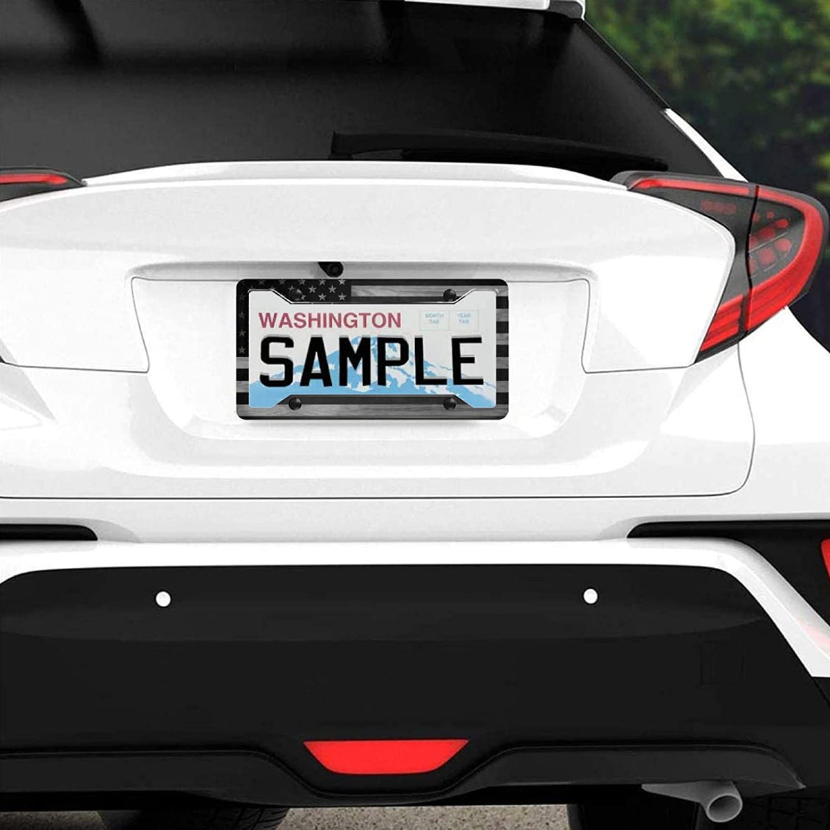 A white car's rear view shows a sample Washington license plate frame.
