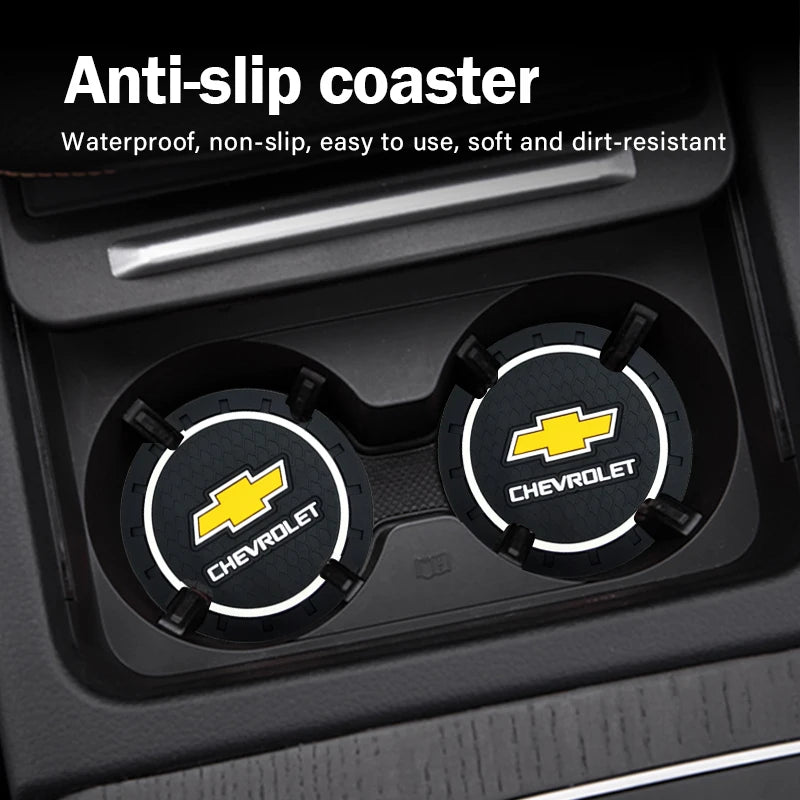A close-up view of a car anti-slip coaster set with Chevrolet branded coasters inside the cup holder.
