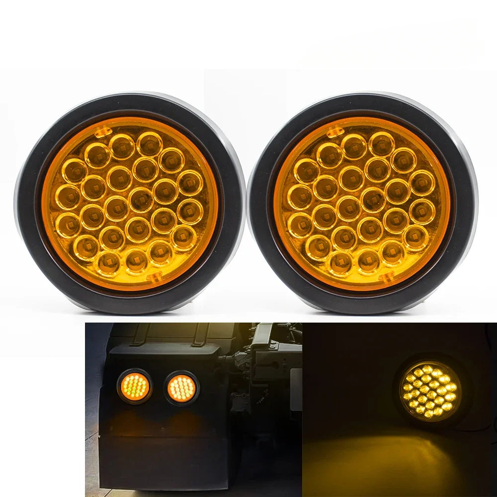 A pair of round LED trailer lights with brake and turn signal functions, shown in close-up and installed on a vehicle.