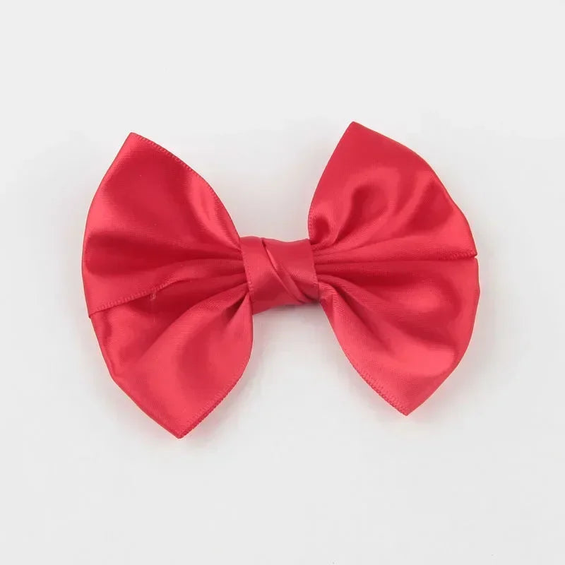 A vibrant red silk bow tied in a classic knot, suitable for a headband or hair accessory.