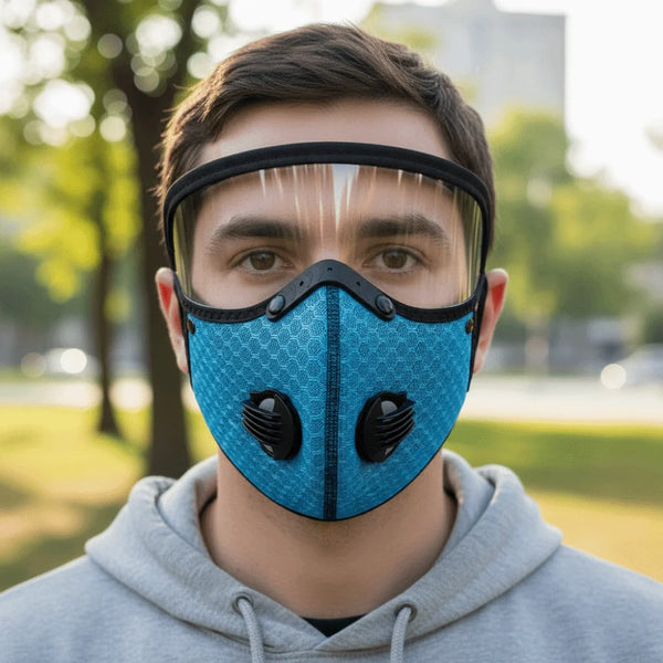 A young man wearing a blue breathable cycling and outdoor face mask outdoors.