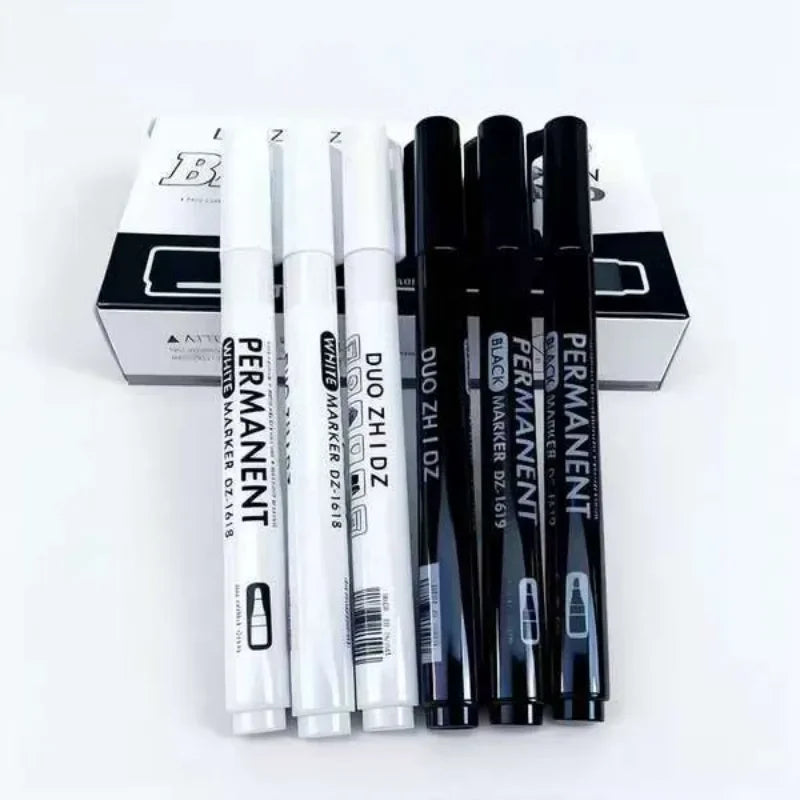 A set of black and white permanent paint markers for art, craft, and DIY displayed in their packaging.