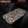 Leopard print plush cover for a car armrest.