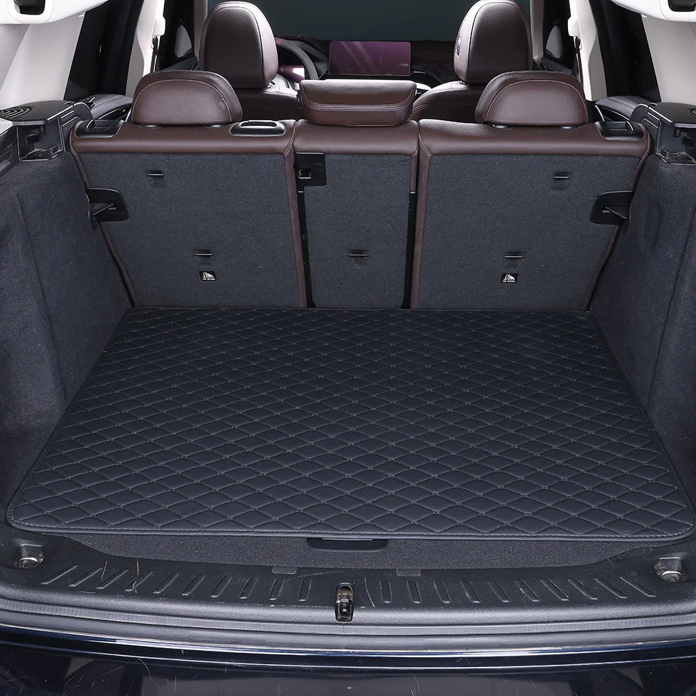 A dark gray car trunk mat with a diamond pattern is shown inside a vehicle cabin.