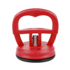 Outil tire-bosses avec ventouse lourde rouge, poignée et base en caoutchouc.
