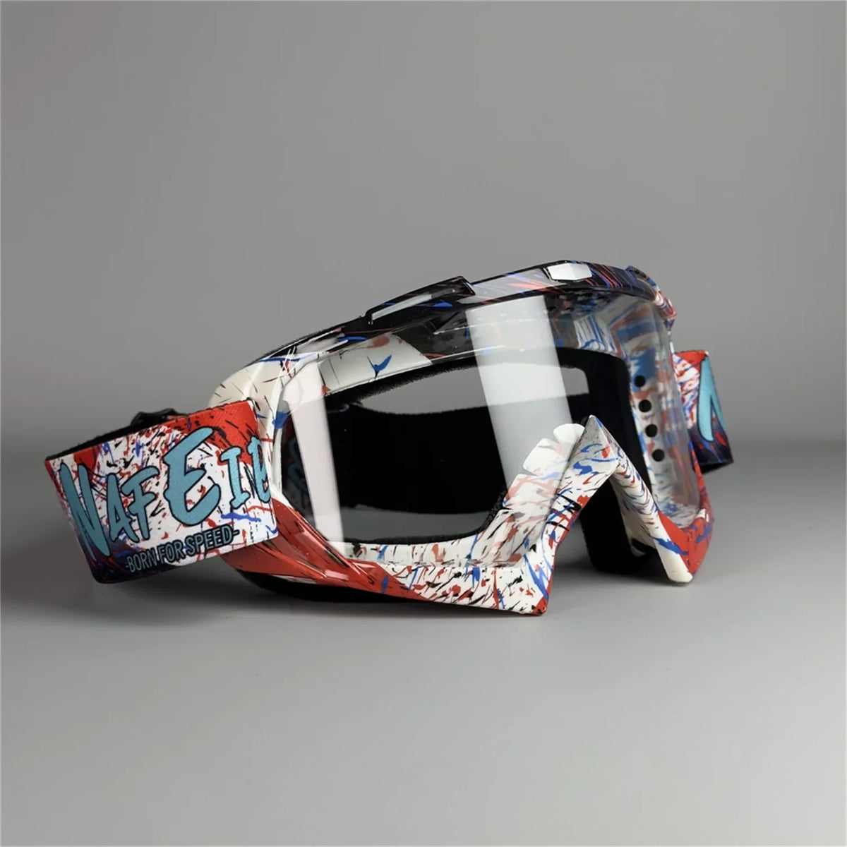 A pair of motorcycle off-road goggles featuring a camouflage pattern with red and white accents.